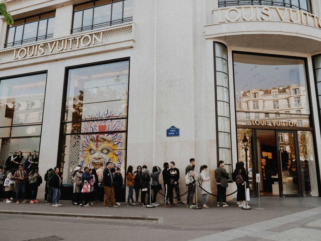 People in the queue to enter the louis vuitton shop